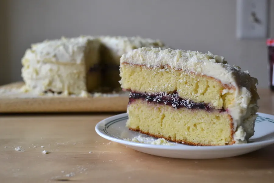 Lemon cake stuffed with bluberry jam and slathered with vanilla buttercream. Full recipe on BigTasteTinySpace.com